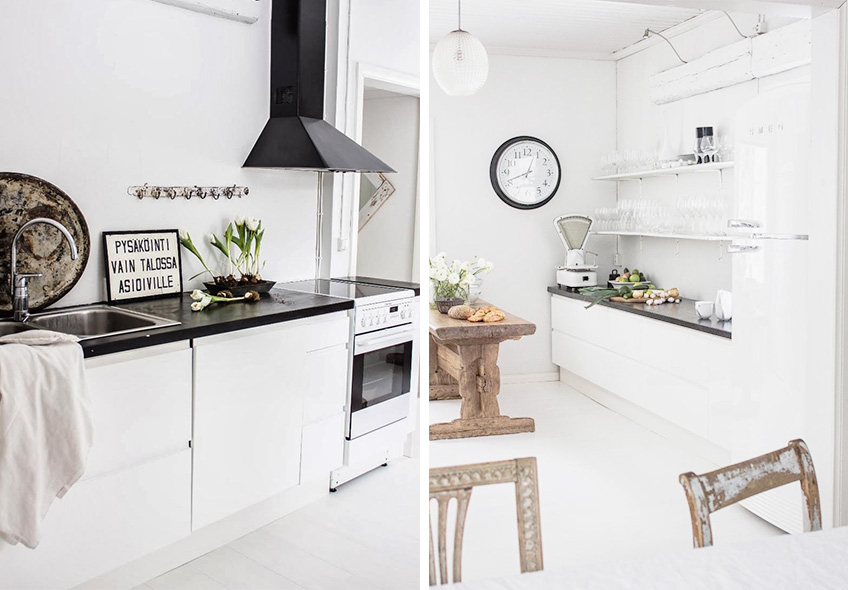 Cocina moderna con gabinetes blancos y una encimera negra, creando un contraste elegante y contemporáneo.